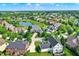 Stunning aerial view of a neighborhood with tree-lined streets, a tranquil lake, and beautiful homes at 14737 Macduff Dr, Noblesville, IN 46062