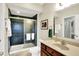 Bathroom featuring a glass enclosed shower with dark tile, wooden vanity, and neutral colored walls at 14737 Macduff Dr, Noblesville, IN 46062
