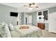 Relaxing bedroom with light green walls, ceiling fan, and large window at 14737 Macduff Dr, Noblesville, IN 46062