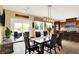 Inviting dining area with sliding door access to a patio and view of kitchen with custom cabinetry at 14737 Macduff Dr, Noblesville, IN 46062