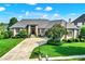 Stunning brick home featuring a grand entrance, manicured lawn, and a circular driveway on a sunny day at 14737 Macduff Dr, Noblesville, IN 46062