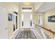 Bright foyer with tiled floor, staircase with wooden railing, and a view of the front door at 14737 Macduff Dr, Noblesville, IN 46062