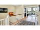 Bright hallway with tiled floors, wooden railings, leading into the living area with large windows at 14737 Macduff Dr, Noblesville, IN 46062