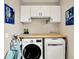Functional laundry room with washer, dryer, butcher block countertop, and storage cabinets at 14737 Macduff Dr, Noblesville, IN 46062