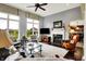 Bright living room with a fireplace, comfortable seating, and natural light from large windows with backyard view at 14737 Macduff Dr, Noblesville, IN 46062