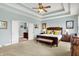 Serene bedroom suite with tray ceiling, ensuite bathroom access, and elegant furnishings at 14737 Macduff Dr, Noblesville, IN 46062