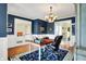 Home office featuring hardwood floors, chandelier lighting, and stylish blue accent walls at 14737 Macduff Dr, Noblesville, IN 46062