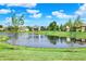 Scenic view of the pond and surrounding community in the backyard at 14737 Macduff Dr, Noblesville, IN 46062