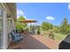 Wooden deck with chairs and a table, an umbrella, fire pit, and view of the backyard at 15372 Black Gold Ct, Noblesville, IN 46060