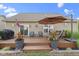 Deck with chairs, umbrella, and potted plants at the back of a house with a nice backyard at 15372 Black Gold Ct, Noblesville, IN 46060