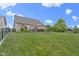 A well maintained lawn with a wooden deck, umbrella, and a fire pit at 15372 Black Gold Ct, Noblesville, IN 46060