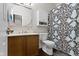 Bright bathroom with stylish vanity, modern toilet, and a shower-tub with shower curtain at 15372 Black Gold Ct, Noblesville, IN 46060