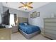 Comfortable bedroom features soft carpet, a ceiling fan, and dresser storage space at 15372 Black Gold Ct, Noblesville, IN 46060