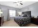 Comfortable bedroom with a plush queen-sized bed, soft carpet, and a ceiling fan at 15372 Black Gold Ct, Noblesville, IN 46060