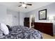 Well-lit bedroom features soft carpet, a ceiling fan, and two large dressers for ample storage space at 15372 Black Gold Ct, Noblesville, IN 46060