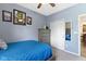 Comfortable bedroom with blue comforter, gray walls, and decorated with interesting art pieces at 15372 Black Gold Ct, Noblesville, IN 46060