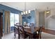Dining area with rich wood table, six chairs, stylish chandelier, and large windows offering bright, natural light at 15372 Black Gold Ct, Noblesville, IN 46060