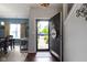 Warm entryway with hardwood floors, leading to a dining area with a charming dog crate under the table at 15372 Black Gold Ct, Noblesville, IN 46060