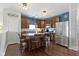 Beautiful kitchen with stainless steel appliances, wood cabinets, a center island, and stylish bar stool seating at 15372 Black Gold Ct, Noblesville, IN 46060