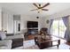 Comfortable living room features hardwood floors, stylish furniture and a sliding glass door leading to the outside at 15372 Black Gold Ct, Noblesville, IN 46060