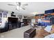 Finished basement with carpet and colorful walls, display cabinets and a large TV at 15372 Black Gold Ct, Noblesville, IN 46060