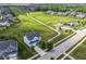 Aerial view of a two-story home nestled within a community featuring green spaces, a pool, and a playground area at 15984 Conductors Dr, Westfield, IN 46074
