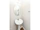Powder room with pedestal sink, oval mirror, and neutral wall paint at 15984 Conductors Dr, Westfield, IN 46074