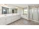 Bathroom with double sink vanity, soaking tub, and glass shower enclosure at 15984 Conductors Dr, Westfield, IN 46074
