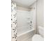 Bathroom features a shower-tub combination with a patterned shower curtain and modern fixtures at 15984 Conductors Dr, Westfield, IN 46074