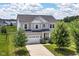 Beautiful two-story home featuring a well-manicured lawn, a two-car garage and traditional architectural details at 15984 Conductors Dr, Westfield, IN 46074