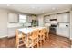Modern kitchen with stainless steel appliances, white cabinetry, and a large center island at 15984 Conductors Dr, Westfield, IN 46074