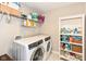 Efficient laundry room featuring a modern washer and dryer set, shelving, and ample storage space for organization at 15984 Conductors Dr, Westfield, IN 46074