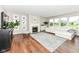 Bright living room with fireplace, hardwood floors, and large windows offering natural light at 15984 Conductors Dr, Westfield, IN 46074