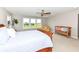 Bright primary bedroom with natural light, bench, and accent chair at 15984 Conductors Dr, Westfield, IN 46074