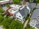 An aerial view of a stylish, modern home with manicured landscaping and a quaint front porch in an urban setting at 1610 N Alabama St, Indianapolis, IN 46202
