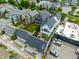 Aerial view features backyard decks, lawns, commercial parking; showcasing neighborhood blend at 1610 N Alabama St, Indianapolis, IN 46202