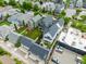 An aerial shot displays manicured backyards and decks, adjacent to commercial parking, with a neighborhood backdrop at 1610 N Alabama St, Indianapolis, IN 46202
