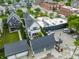 An aerial view shows a house with a stone patio and manicured landscaping, providing a private outdoor oasis at 1610 N Alabama St, Indianapolis, IN 46202