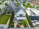 Aerial view highlights private backyard with a stone patio, lush landscaping, and a seating area at 1610 N Alabama St, Indianapolis, IN 46202