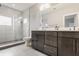 Modern bathroom featuring a walk-in glass shower and double vanity with sleek, dark wood cabinetry at 1610 N Alabama St, Indianapolis, IN 46202