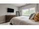 Cozy bedroom featuring a large window, dresser, and soft natural light at 1610 N Alabama St, Indianapolis, IN 46202