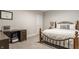 Comfortable bedroom featuring a wooden-framed bed, desk, and neutral decor at 1610 N Alabama St, Indianapolis, IN 46202