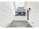 Exterior view of a deck with gray composite decking between home's white vinyl siding at 1610 N Alabama St, Indianapolis, IN 46202
