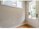 Bright entryway featuring hardwood floors, window, and frosted glass door at 1610 N Alabama St, Indianapolis, IN 46202