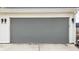 A single-car garage with a gray door and white trim at 1610 N Alabama St, Indianapolis, IN 46202
