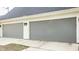 A two-car garage with gray doors and white trim at 1610 N Alabama St, Indianapolis, IN 46202