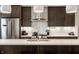 Modern kitchen featuring stainless steel appliances, white countertops, and stylish lighting fixtures at 1610 N Alabama St, Indianapolis, IN 46202