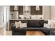 Open-concept living room showcasing a stylish kitchen with stainless steel appliances and a comfortable couch at 1610 N Alabama St, Indianapolis, IN 46202
