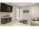 Well-lit living room with a sectional sofa, mounted television, and modern decor at 1610 N Alabama St, Indianapolis, IN 46202