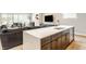Open floor plan with a modern kitchen island flowing into the living and dining areas at 1610 N Alabama St, Indianapolis, IN 46202
